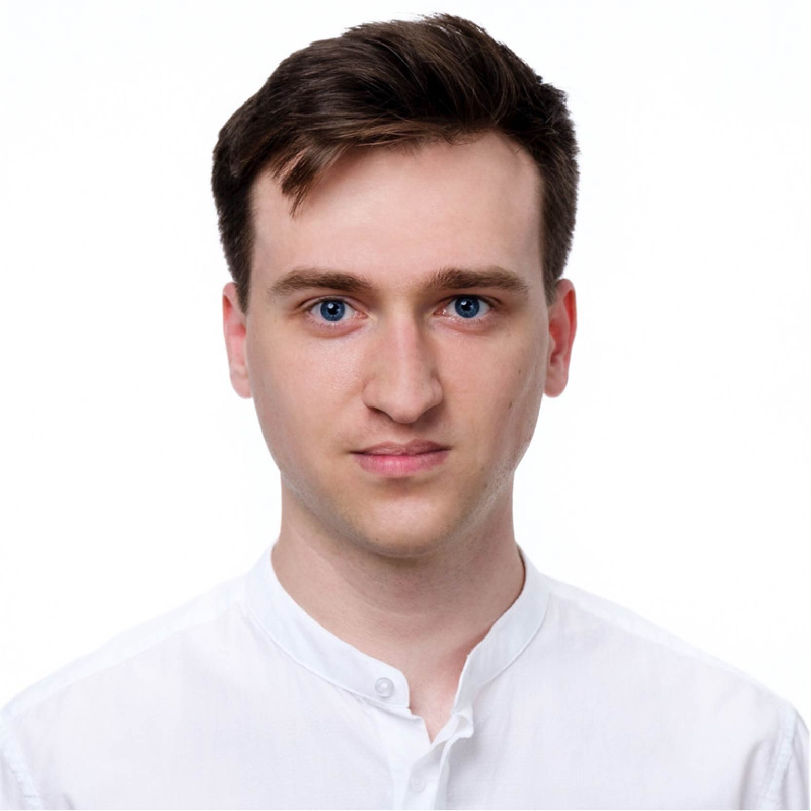 Portrait photo of Bartłomiej Król-Józaga, PhD student, wearing a white shirt, with brown hair and blue eyes.